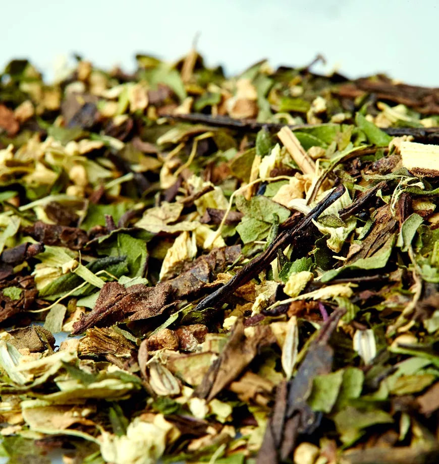 A white surface displays a pile of dried Moorish Mint herbs, ideal for brewing herbal tea.