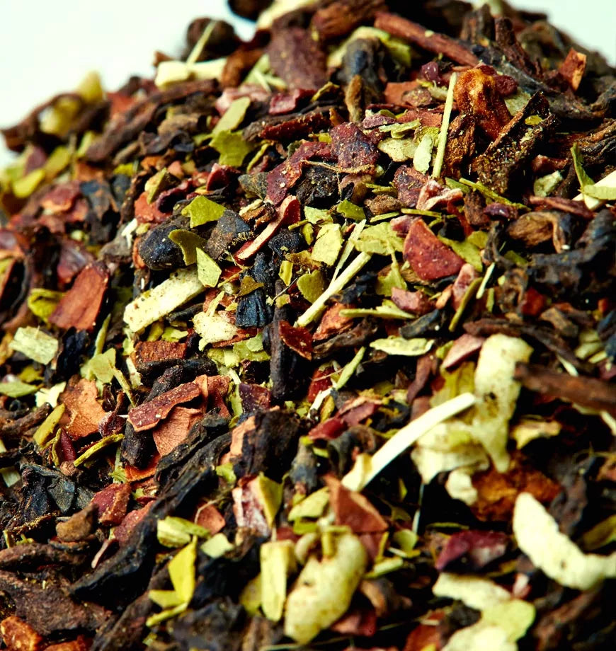 Dried and ground Velvet Cacao pu erh tea combined with nuts and seeds, displayed in a small mound.