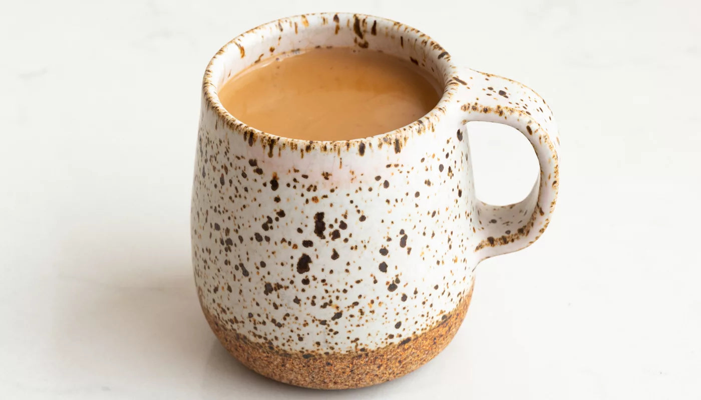 A Chai Mug featuring a brown and white speckled design.