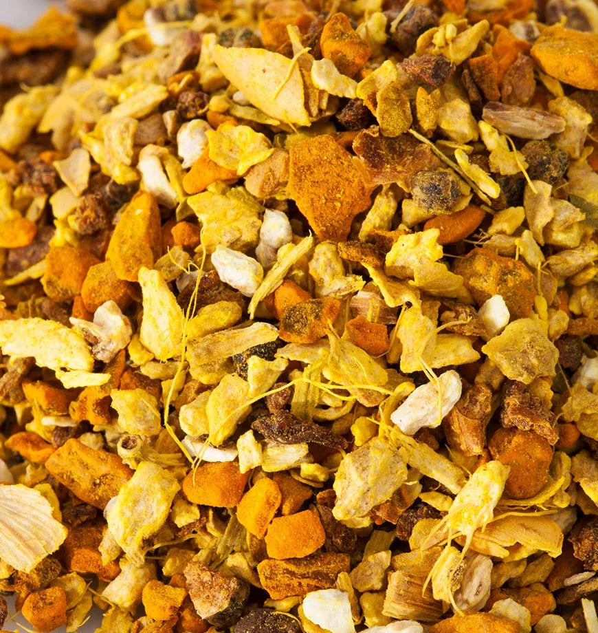 A colorful pile of dried fruit and nuts, showcasing a variety of textures and colors, with a hint of turmeric infusion.